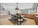Open dining area seamlessly connects living area, featuring an elegant table set, hardwood floors, and modern design at 9006 E 60Th Ave, Denver, CO 80238