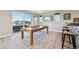 Game room with large sliding glass door to an outside deck and entertainment area at 9006 E 60Th Ave, Denver, CO 80238