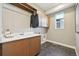 Functional laundry room with sink, storage cabinets, and ample counter space at 9006 E 60Th Ave, Denver, CO 80238