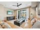 Stylish living room boasts a large sliding door, modern furnishings, and recessed lighting at 9006 E 60Th Ave, Denver, CO 80238