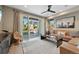 Bright living room features a tan sofa, modern decor, and sliding glass doors leading to the outdoor space at 9006 E 60Th Ave, Denver, CO 80238