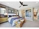 Inviting main bedroom with a modern accent wall, stylish decor, and plenty of natural light at 9006 E 60Th Ave, Denver, CO 80238