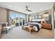 Bright main bedroom boasts a private balcony, modern decor, and an abundance of natural light at 9006 E 60Th Ave, Denver, CO 80238
