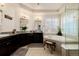 A spacious bathroom features dual sinks, granite countertops, and a soaking tub with a plant at 15205 W Iliff Ave, Lakewood, CO 80228