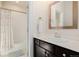This updated bathroom features a single sink vanity, a mirrored medicine cabinet, and a shower/tub combo at 15205 W Iliff Ave, Lakewood, CO 80228