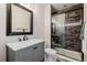 Bathroom features modern vanity, glass enclosed shower, and decorative tile floors at 15205 W Iliff Ave, Lakewood, CO 80228