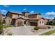 Stunning two-story home featuring a tile roof and stone accents with a spacious three car driveway at 15205 W Iliff Ave, Lakewood, CO 80228