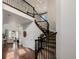 Elegant foyer with a curved staircase, hardwood floors, and a view into the living room at 15205 W Iliff Ave, Lakewood, CO 80228
