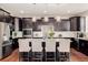 Modern kitchen with stainless steel appliances, quartz countertops, and a center island with seating at 15205 W Iliff Ave, Lakewood, CO 80228
