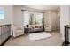 Bright loft area with a cozy seating arrangement and large window offering natural light at 15205 W Iliff Ave, Lakewood, CO 80228
