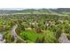 Aerial view showcasing the neighborhood's lush greenery, community parks, and mountain views at 13 Pinyon Pine Rd, Littleton, CO 80127