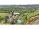 Aerial view of the community's tennis courts, pool, and surrounding buildings at 13 Pinyon Pine Rd, Littleton, CO 80127
