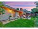 Backyard view showing fire pit and seating area on a well-maintained lawn at 13 Pinyon Pine Rd, Littleton, CO 80127