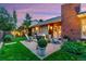 Backyard featuring a fire pit with adirondack chairs surrounded by green grass at 13 Pinyon Pine Rd, Littleton, CO 80127