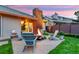 Beautiful backyard featuring a fire pit surrounded by chairs and manicured landscaping at 13 Pinyon Pine Rd, Littleton, CO 80127
