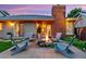 Cozy backyard patio with stone fireplace, Adirondack chairs and exterior doors at 13 Pinyon Pine Rd, Littleton, CO 80127