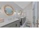 Elegant bathroom featuring dual vanities, stylish mirrors, and a glass-enclosed shower at 13 Pinyon Pine Rd, Littleton, CO 80127