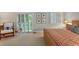 Relaxing bedroom with woven-style bed frame, neutral carpet, and access to the outdoors at 13 Pinyon Pine Rd, Littleton, CO 80127