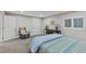 Cozy bedroom featuring a patterned quilt, white shutters and a comfortable sitting area at 13 Pinyon Pine Rd, Littleton, CO 80127