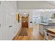 Foyer view into the kitchen area, featuring hardwood floors and natural light at 13 Pinyon Pine Rd, Littleton, CO 80127