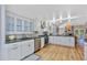 Spacious kitchen featuring white cabinets, stainless appliances, and hardwood floors at 13 Pinyon Pine Rd, Littleton, CO 80127