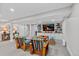 Spacious living room featuring built-in shelving, a TV, and comfortable seating on a carpeted floor at 13 Pinyon Pine Rd, Littleton, CO 80127