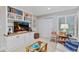 Inviting living room featuring built-in shelving, a TV, and comfortable seating, creating a cozy atmosphere at 13 Pinyon Pine Rd, Littleton, CO 80127