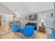 Open living room boasts hardwood floors, vaulted ceilings, and shuttered windows at 13 Pinyon Pine Rd, Littleton, CO 80127