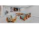 Open living room with modern furnishings, built-in shelving, and TV for cozy entertainment at 13 Pinyon Pine Rd, Littleton, CO 80127