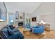 Inviting living room showcases a brick fireplace, comfortable seating, and bright natural light at 13 Pinyon Pine Rd, Littleton, CO 80127