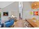Spacious living area with vaulted ceilings, hardwood floors, and a built-in entertainment center at 13 Pinyon Pine Rd, Littleton, CO 80127