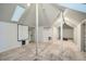 Unfinished basement with exposed beams, skylight, neutral carpet, and potential for customization at 5127 Lowell Blvd, Denver, CO 80221