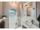 Well-lit bathroom featuring a unique archway for shower and white-painted walls at 5127 Lowell Blvd, Denver, CO 80221