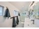 Bright bathroom with a glass-enclosed shower, dual sinks, and sleek fixtures, offering a modern and clean aesthetic at 5127 Lowell Blvd, Denver, CO 80221