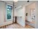 Bright bedroom with hardwood floors, closet, large window, decorative trim, and adjacent access to another room at 5127 Lowell Blvd, Denver, CO 80221