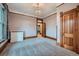 Elegant bedroom showcasing beautiful wood trim, soft carpeting, and a glimpse into an adjacent room at 5127 Lowell Blvd, Denver, CO 80221