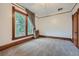 Spacious bedroom with large windows, wood trim, and neutral carpet, offering plenty of natural light and comfort at 5127 Lowell Blvd, Denver, CO 80221