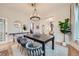 Spacious dining room with gray cushioned chairs and hardwood flooring at 5127 Lowell Blvd, Denver, CO 80221