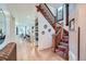 Inviting entryway with a wood staircase and access to the kitchen, blending classic charm and modern convenience at 5127 Lowell Blvd, Denver, CO 80221