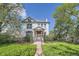 Inviting home with a well-maintained lawn, established trees, and a welcoming front porch at 5127 Lowell Blvd, Denver, CO 80221