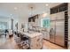 Open kitchen featuring a center island with bar stools and stainless steel appliances at 5127 Lowell Blvd, Denver, CO 80221