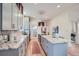 Bright kitchen featuring a center island with bar stools and stainless steel appliances at 5127 Lowell Blvd, Denver, CO 80221
