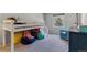 A playful bedroom includes a bunk bed with colorful storage and a comfortable sitting area by the window at 6918 E Easter, Centennial, CO 80112