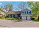 Charming two-story home with a well-manicured lawn, blue shutters, and an attached two-car garage at 6918 E Easter, Centennial, CO 80112
