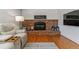 Brick fireplace in living room features a wood mantel, decor, and a cozy ambiance at 6918 E Easter, Centennial, CO 80112