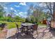 Outdoor patio features brick pavers and backyard views of trees and landscaping at 6918 E Easter Pl, Centennial, CO 80112