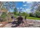 Outdoor patio features brick pavers and backyard views of trees and landscaping at 6918 E Easter Pl, Centennial, CO 80112