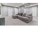 Spacious basement featuring a large sectional sofa and neutral decor at 6918 E Easter Pl, Centennial, CO 80112