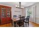Formal dining room featuring a beautiful table, hardwood floors, and a display cabinet for elegant entertaining at 6918 E Easter Pl, Centennial, CO 80112
