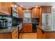 Beautiful kitchen featuring stainless steel appliances, granite countertops, and rich wood cabinetry at 6918 E Easter Pl, Centennial, CO 80112